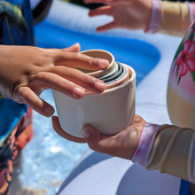Load image into Gallery viewer, A child is holding a cup in an inflatable pool.